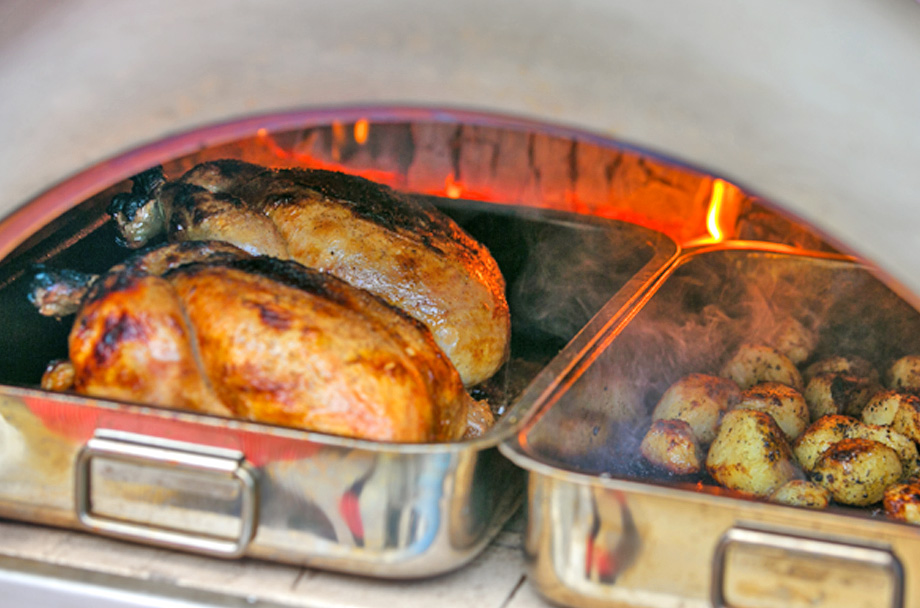 Igneus Classico pizza oven cooking roast chicken and roast potatoes
