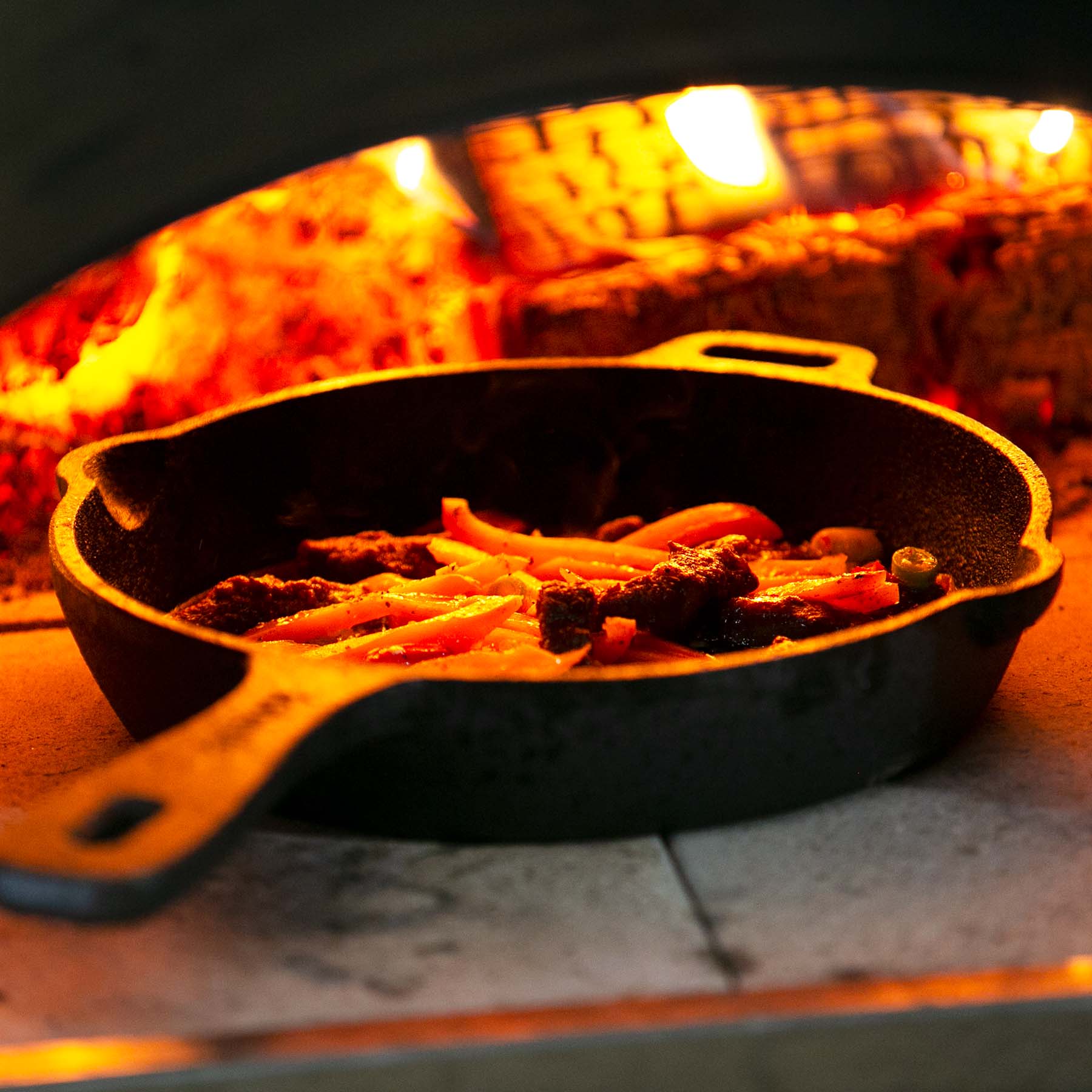 Cooking on an open fire in a cast iron pan. : r/castiron